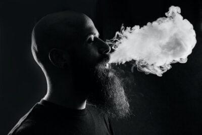 man smoking with black background world of cannabis